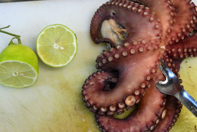 High angle view of octopus with lemon on plate