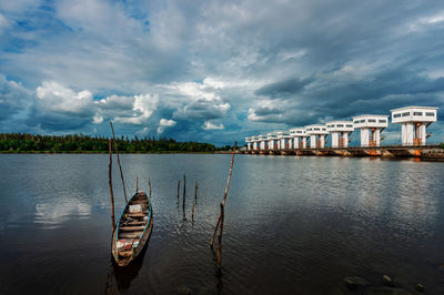 Boats in river against sky