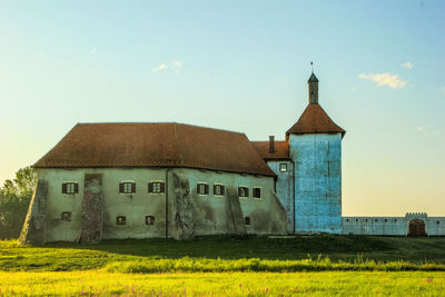 Old building on field against sky