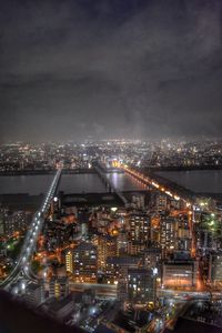 Aerial view of city lit up at night