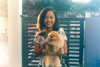 Portrait of smiling young woman with dog