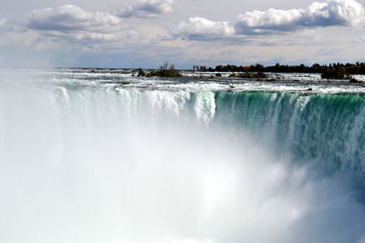 Panoramic view of waterfall against sky