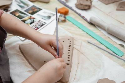 Women's hands knead clay, drawing elements of the product. production of ceramic products. 