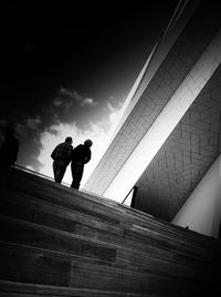 Low angle view of people standing on steps