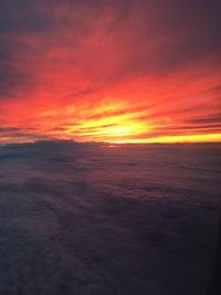 Scenic view of sea against cloudy sky at sunset