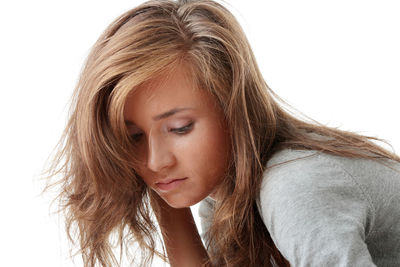 Close-up portrait of a beautiful young woman over white background