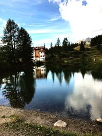 Scenic view of lake by building against sky