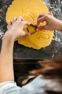Low section of woman holding heart shape