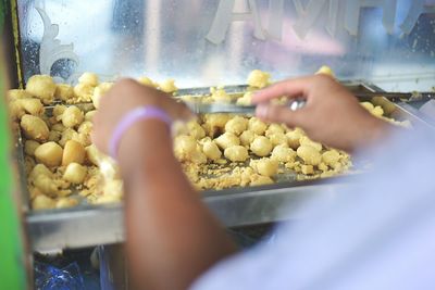 Close-up of man preparing food