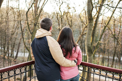 Young loving couple enjoy the sun and warm stroll in the spring park