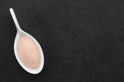 High angle view of bread in bowl against black background