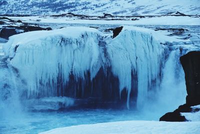 Frozen lake along snowed landscape