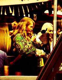 Rear view of women sitting in store