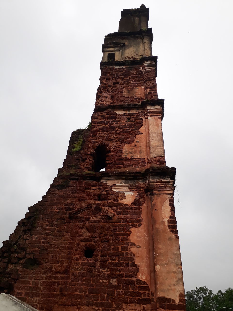 LOW ANGLE VIEW OF A TOWER OF A TEMPLE