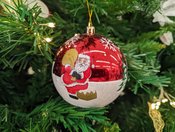 Close-up of bauble hanging on christmas tree