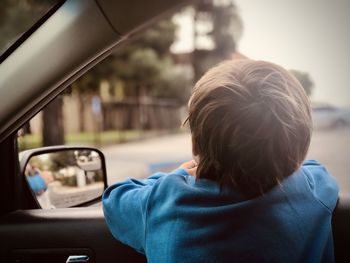 Rear view of boy in car