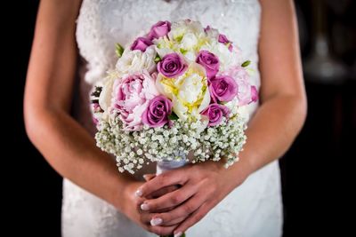 Midsection of woman holding flower bouquet