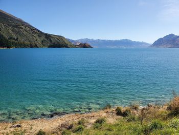 Scenic view of sea against clear blue sky