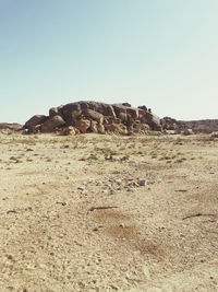 Scenic view of rocks on land against clear sky