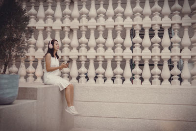 Rear view of woman sitting on chair