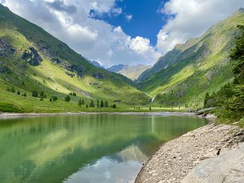 Scenic view of lake and mountains against sky