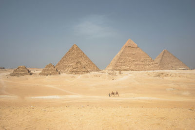 Scenic view of desert against clear blue sky