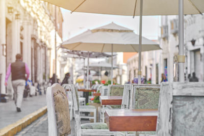 Outdoor cafe on cobblestone street, picturesque street with traditional houses and cafe tables 