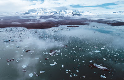 Aerial view of frozen sea against sky