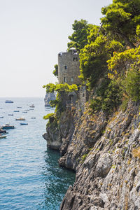 Rock formations by sea against sky