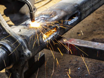 Metal work. man cuts a hole in a steel piece using gas welding