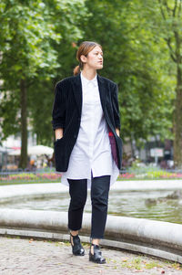 Full length of young woman walking in park