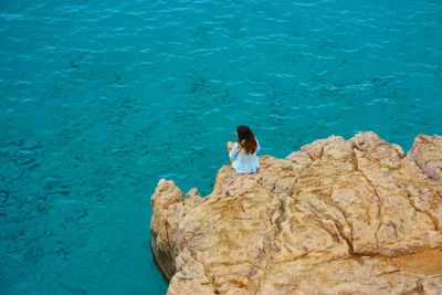 High angle view of woman swimming in sea