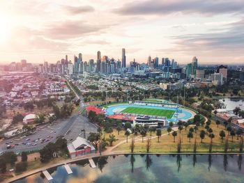 Aerial view of melbourne city buildings against sky during sunset