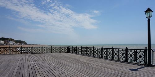 Pier over sea against sky