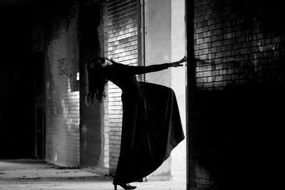 Woman dancing by wall