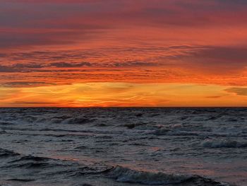 Scenic view of sea against romantic sky at sunset