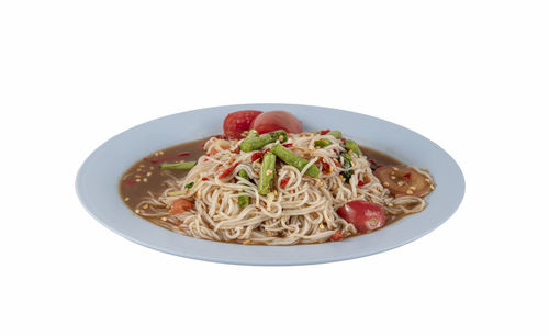 Close-up of noodles in bowl against white background