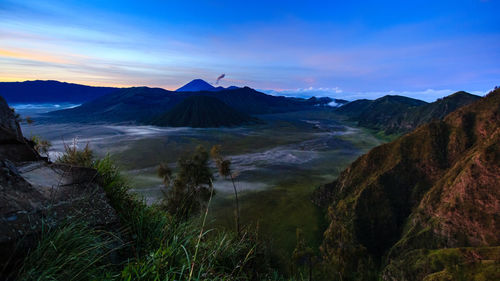 Scenic view of mountains against cloudy sky