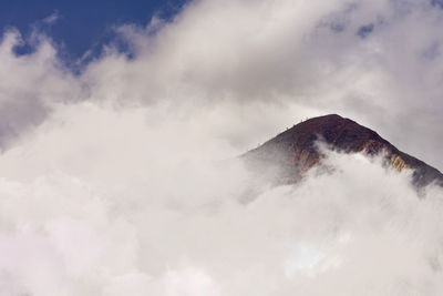 Low angle view of volcanic mountain against sky