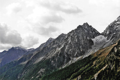 Scenic view of mountains against cloudy sky