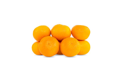 Close-up of orange fruit against white background