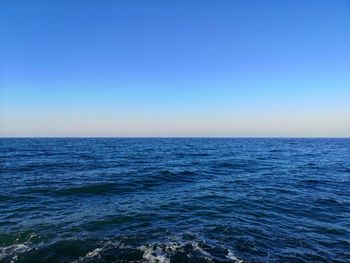 Scenic view of sea against clear blue sky