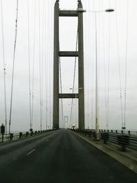 Road by bridge against sky