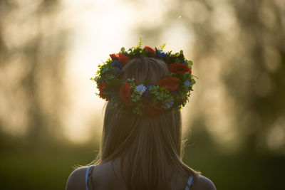 Rear view of woman with pink flower