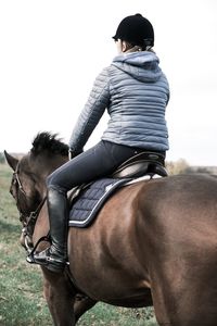 Midsection of man riding horse