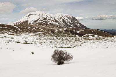 Scenic view of snow covered mountain against sky