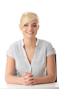 Portrait of a smiling young woman over white background