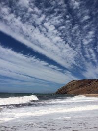 Scenic view of sea against cloudy sky