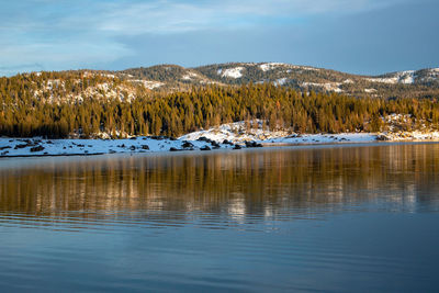 Scenic view of lake against sky during winter