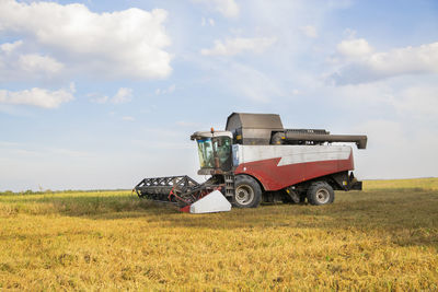 Tractor on field against sky